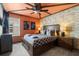 Inviting bedroom with a brick accent wall, wooden furniture, and a ceiling fan at 1986 Summer Dr, Davenport, FL 33897