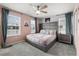 Stylish bedroom featuring a large bed, elegant decor, and ample natural light from multiple windows at 1986 Summer Dr, Davenport, FL 33897