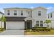 Charming two-story home with a stone facade, paver driveway and well-manicured landscaping at 1986 Summer Dr, Davenport, FL 33897