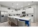 Bright kitchen featuring a large island with seating, white cabinetry, and stainless steel appliances at 1986 Summer Dr, Davenport, FL 33897