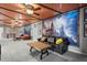 Living room showcases a themed design, comfortable seating, and a mural wall for added character at 1986 Summer Dr, Davenport, FL 33897
