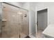 Neutral tiled shower stall featuring glass doors, and an adjacent door at 1986 Summer Dr, Davenport, FL 33897
