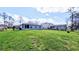 Green backyard with the exterior of the home at 2016 West Pkwy, Deland, FL 32724