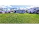 Expansive backyard with green lawn and exterior view of the home at 2016 West Pkwy, Deland, FL 32724