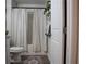 Clean bathroom with tub shower, patterned curtains and rug at 2016 West Pkwy, Deland, FL 32724