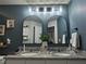 Modern bathroom with double vanity, granite countertop and arched mirrors at 2016 West Pkwy, Deland, FL 32724