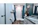 Bathroom with shower, granite countertop and vanity, and wood-look flooring at 2016 West Pkwy, Deland, FL 32724