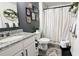 Bathroom with framed art, granite countertop, patterned shower curtain and unique wall decor at 2016 West Pkwy, Deland, FL 32724