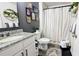 Beautiful bathroom featuring a granite vanity, plants, and a shower/tub with curtain at 2016 West Pkwy, Deland, FL 32724