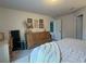 Spacious bedroom with dresser, cozy bed, and wall art at 2016 West Pkwy, Deland, FL 32724