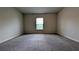 Comfortable bedroom features neutral carpeting, a window, and ample space at 2016 West Pkwy, Deland, FL 32724