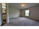 Bedroom with neutral carpet, natural light, and en-suite bathroom access at 2016 West Pkwy, Deland, FL 32724