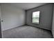 Cozy bedroom featuring neutral carpeting, window with blinds, and a neutral paint color at 2016 West Pkwy, Deland, FL 32724