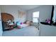 Bright bedroom with a daybed, desk, and decorative chair for a comfortable and stylish space at 2016 West Pkwy, Deland, FL 32724