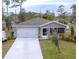 Newly constructed home with gray exterior, white garage door, and landscaped yard at 2016 West Pkwy, Deland, FL 32724