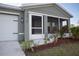 Front entrance with a screened porch and well-maintained landscaping at 2016 West Pkwy, Deland, FL 32724