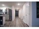 Bright hallway with wood-look floors connecting kitchen to other rooms at 2016 West Pkwy, Deland, FL 32724