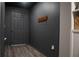 Modern hallway with dark walls and a built-in shelving unit at 2016 West Pkwy, Deland, FL 32724