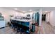 A kitchen with white cabinets, granite countertops and stainless steel appliances and black barstools at 2016 West Pkwy, Deland, FL 32724