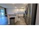 Bright kitchen with stainless steel refrigerator, granite countertops, and modern appliances at 2016 West Pkwy, Deland, FL 32724