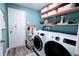 Laundry room featuring a washer, dryer, shelves, and an organized space at 2016 West Pkwy, Deland, FL 32724