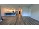 Spacious living room with wood flooring and a view of the open-concept kitchen at 2016 West Pkwy, Deland, FL 32724