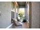 A cozy screened patio with neutral colored wicker furniture and potted plants at 2016 West Pkwy, Deland, FL 32724