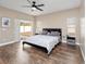 Main bedroom with king bed, backyard access, and wood-look floors at 2078 Marsh Hawk Dr, Orlando, FL 32837