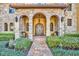 Elegant entry with stone arches and double doors at 2185 Talman Court, Winter Park, FL 32792