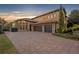 Three-car garage with paver driveway and stone accents at 2185 Talman Court, Winter Park, FL 32792