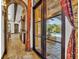 Elegant hallway with arched doorways leading to the pool and other rooms at 2185 Talman Court, Winter Park, FL 32792