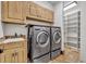 Laundry room with washer, dryer, and cabinets at 2185 Talman Court, Winter Park, FL 32792