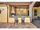 Outdoor kitchen with granite countertops and two barstools at 2185 Talman Court, Winter Park, FL 32792