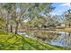 Serene pond with wooden footbridge and lush landscaping at 2185 Talman Court, Winter Park, FL 32792