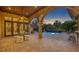 Relaxing pool area at sunset with covered patio and outdoor kitchen at 2185 Talman Court, Winter Park, FL 32792