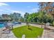 Relaxing poolside patio with artificial turf and wooden chairs at 2185 Talman Court, Winter Park, FL 32792