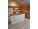 Galley kitchen with wood cabinets and a breakfast bar at 220 Ronaldale Ave, Haines City, FL 33844