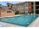 Community pool with surrounding apartment buildings at 2216 Grand Cayman Ct # 1415, Kissimmee, FL 34741