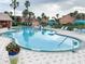 Community pool with lounge chairs at 2216 Grand Cayman Ct # 1415, Kissimmee, FL 34741