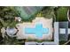 Community pool, tennis courts, and surrounding buildings from above at 264 Celebration Blvd # 264, Celebration, FL 34747