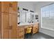 Modern bathroom with a double vanity and herringbone tile floor at 264 Celebration Blvd # 264, Celebration, FL 34747