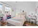 Charming bedroom with light pink bedding and ample storage at 264 Celebration Blvd # 264, Celebration, FL 34747