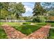 Landscaped courtyard with brick pathways and benches at 264 Celebration Blvd # 264, Celebration, FL 34747