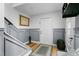 Bright and airy entryway with gray wainscoting, wood floors, and staircase at 264 Celebration Blvd # 264, Celebration, FL 34747