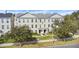 Three story building with classic architecture, manicured lawn, and ample parking at 264 Celebration Blvd # 264, Celebration, FL 34747