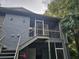 Exterior view of a two-story condo showing stair access to a screened porch with aluminum railings at 306 Northlake Dr # 306, Sanford, FL 32773