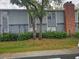 Two-story condo building exterior featuring trees and brick chimney at 306 Northlake Dr # 306, Sanford, FL 32773