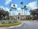 Community clubhouse with palm trees and flagpole at 3264 River Branch Cir, Kissimmee, FL 34741