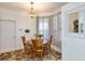 Bright dining area with wood table and chairs, complemented by a floral rug and bay window at 3264 River Branch Cir, Kissimmee, FL 34741