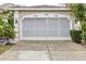 Tan house with white screened garage door at 3264 River Branch Cir, Kissimmee, FL 34741